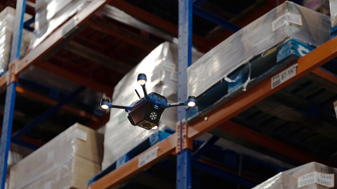 A Corvus autonomous inventory drone scanning pallets inside a warehouse rack.