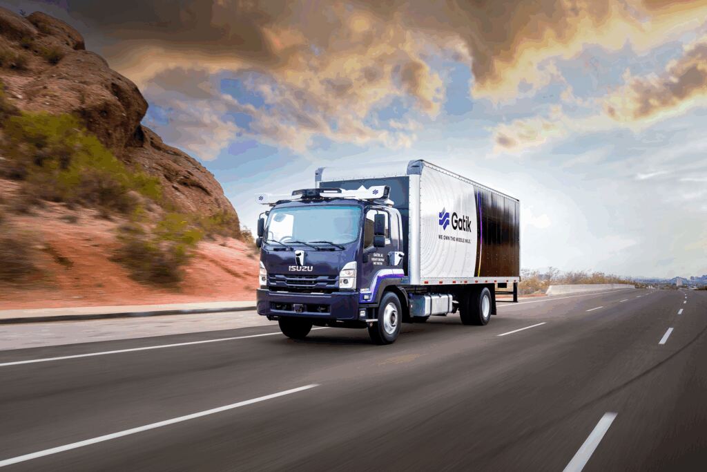 A Gatik autonomous middle-mile box truck travelling on a highway.