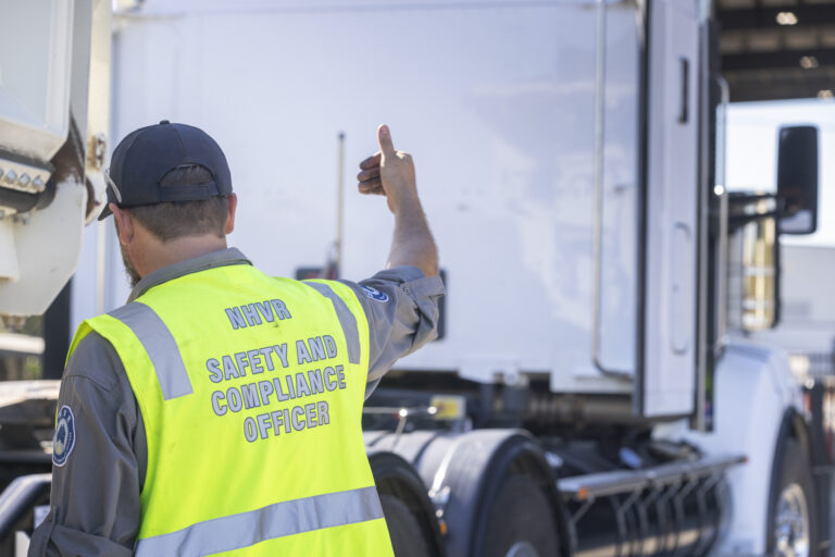 NHVR Safety and Compliance Officer conducting heavy-vehicle compliance activity in Queensland