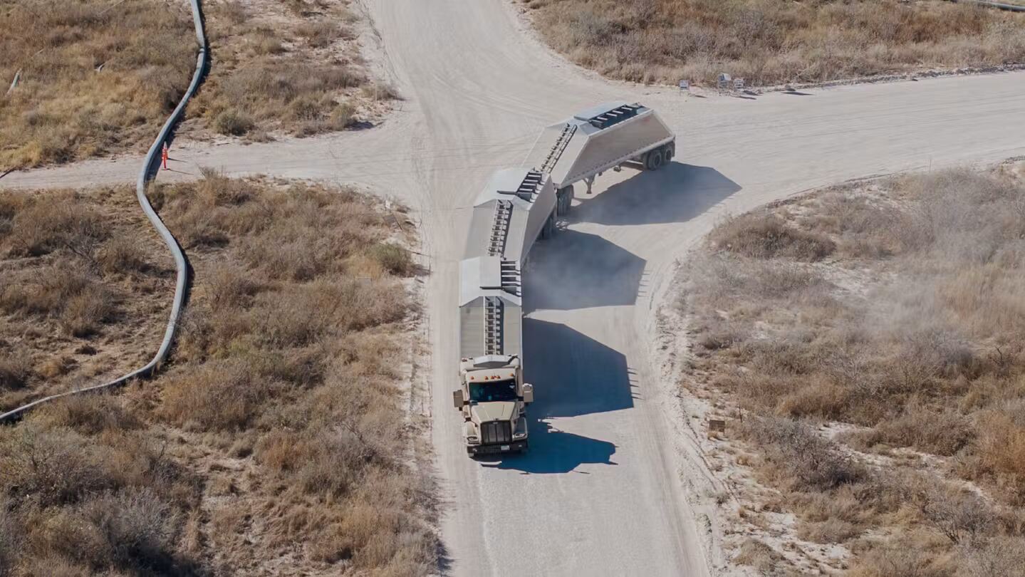 Aerial view of a Kodiak-powered truck hauling three trailers through the Permian Basin.