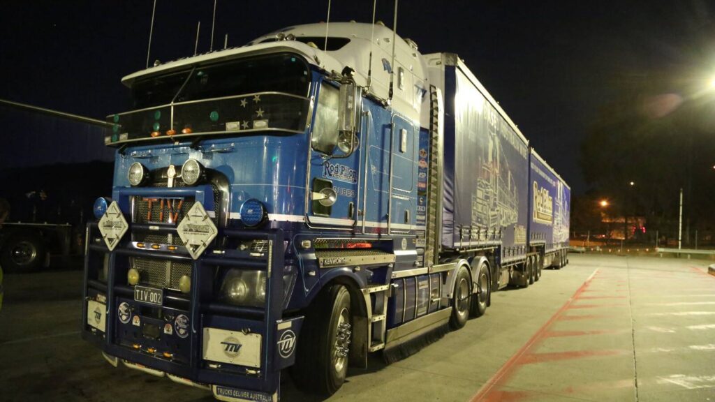 Rod Pilon Transport blue B-double parked at BP Heathwood at night.